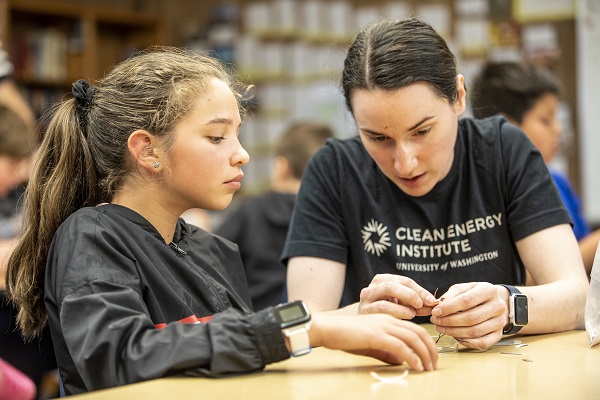 CEI education fellow Erin Jedlicka helps a student